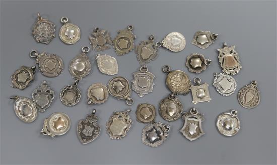 A collection of assorted medallions including silver football related.